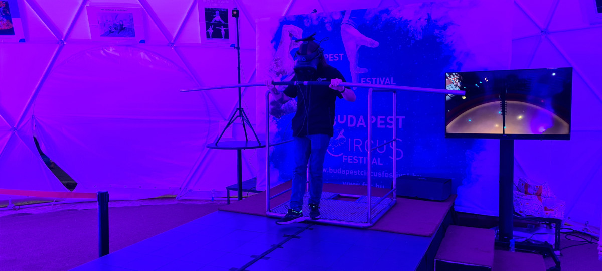 man wearing VR headset balancing with a stick