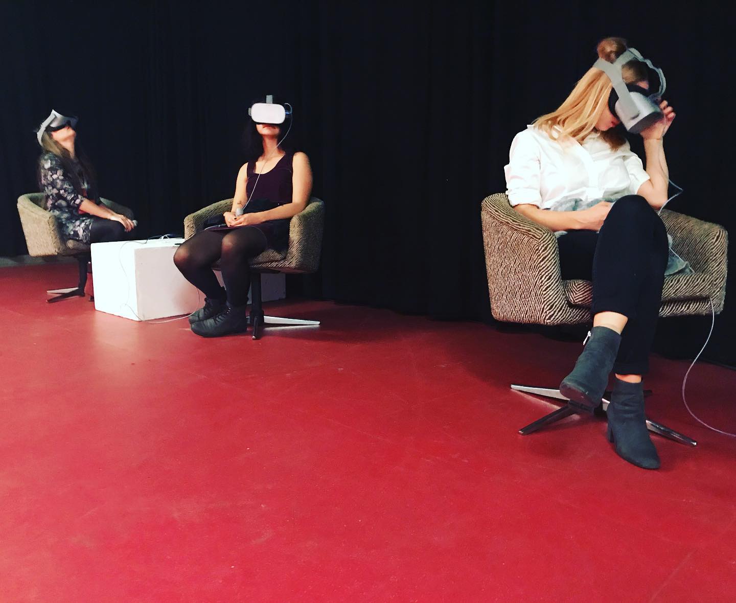 three girls wearing VR headsets sitting in armchairs
              