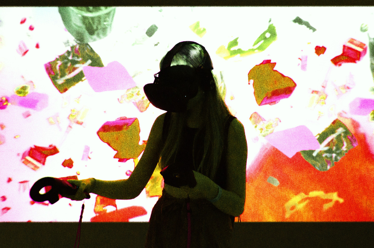 woman wearing VR headset in front of a projected video