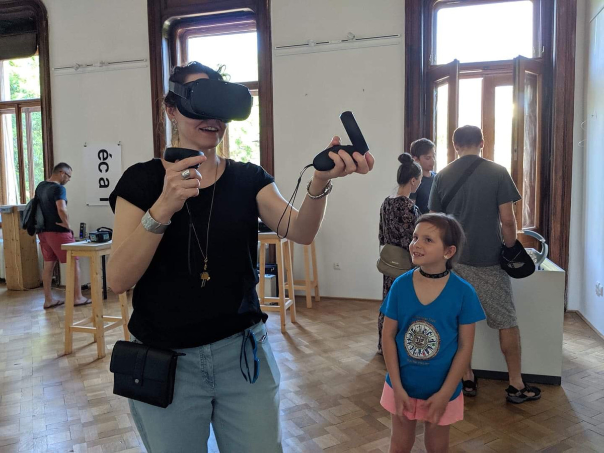 woman smiling in virtual reality headset and the visitors of Sensorium Festival