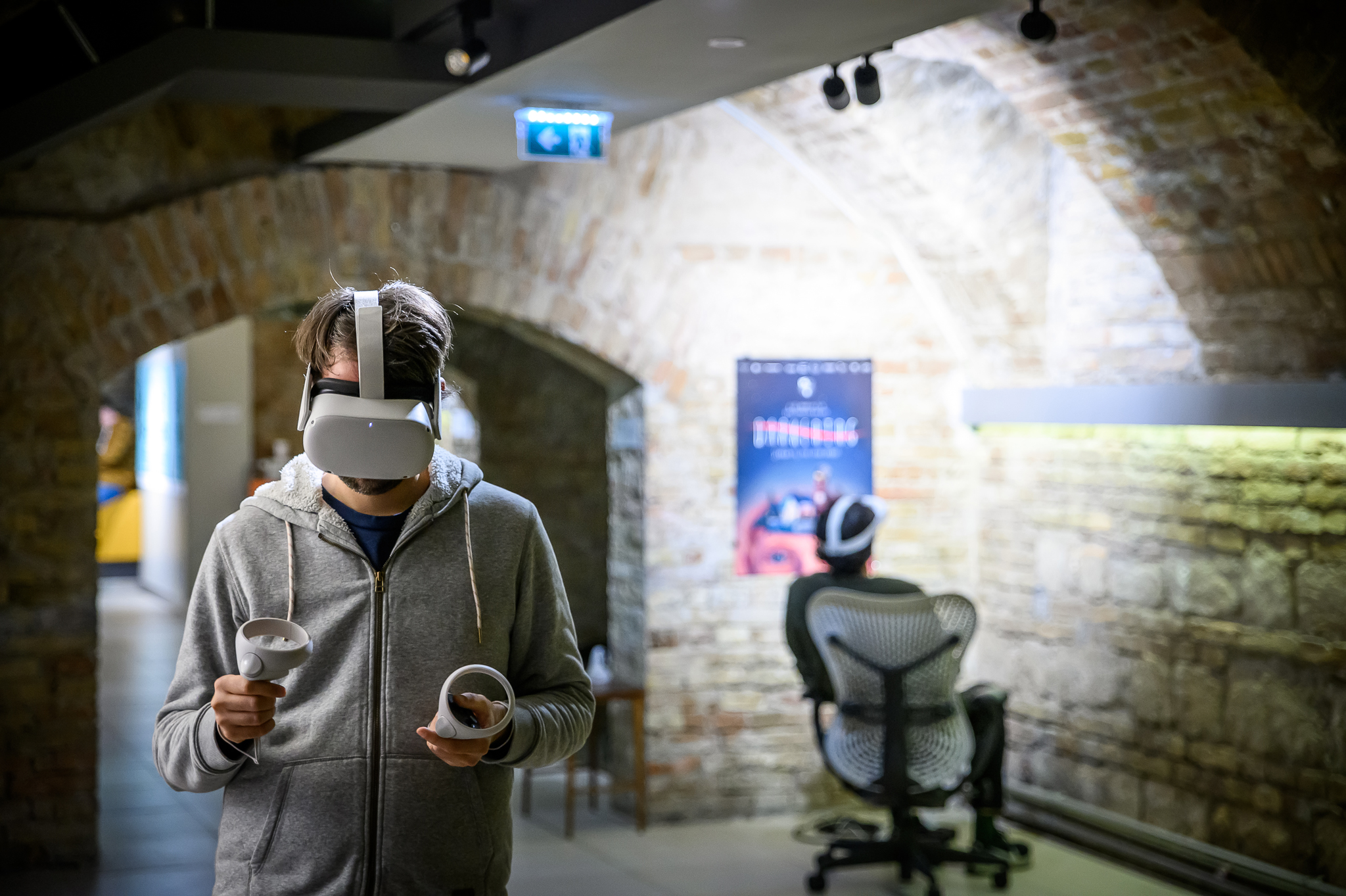 man wearing a VR headset using controllers