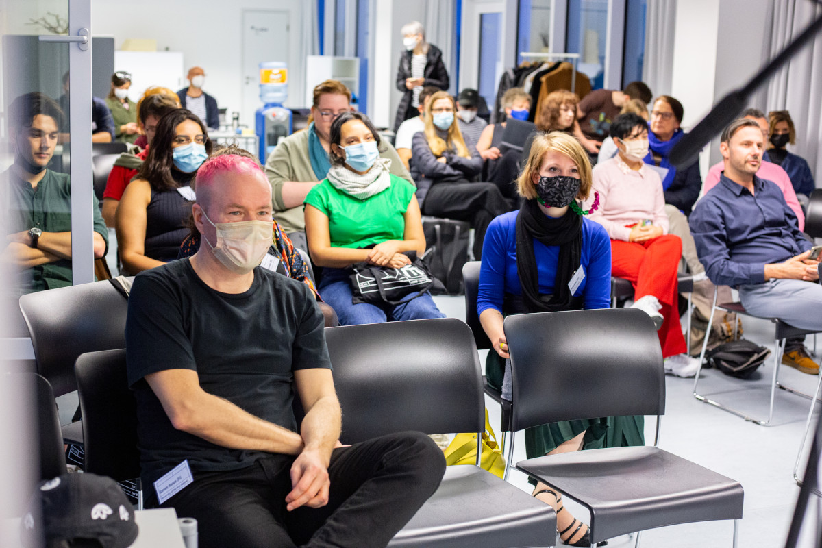 audience of Zip-Scene 2021 wearing masks and sitting on chairs